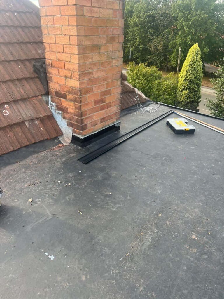 This is a photo of a flat roof which has just been repaired, there is also a chimney stack and some leadwork has also been dressed. Works carried out by LS Roofing Staines-upon-Thames